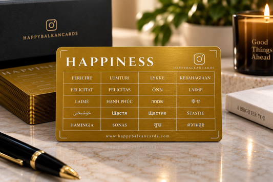 Happiness Card — gold aluminium card, front side with the word Happiness in 20 languages